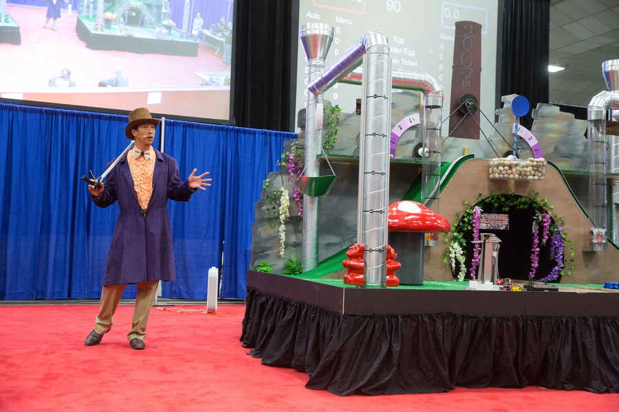 Dressed as Willy Wonka, Associate Professor Sangbae Kim introduces the game board — designed to look like the “Chocolate Room” from the book and movie.