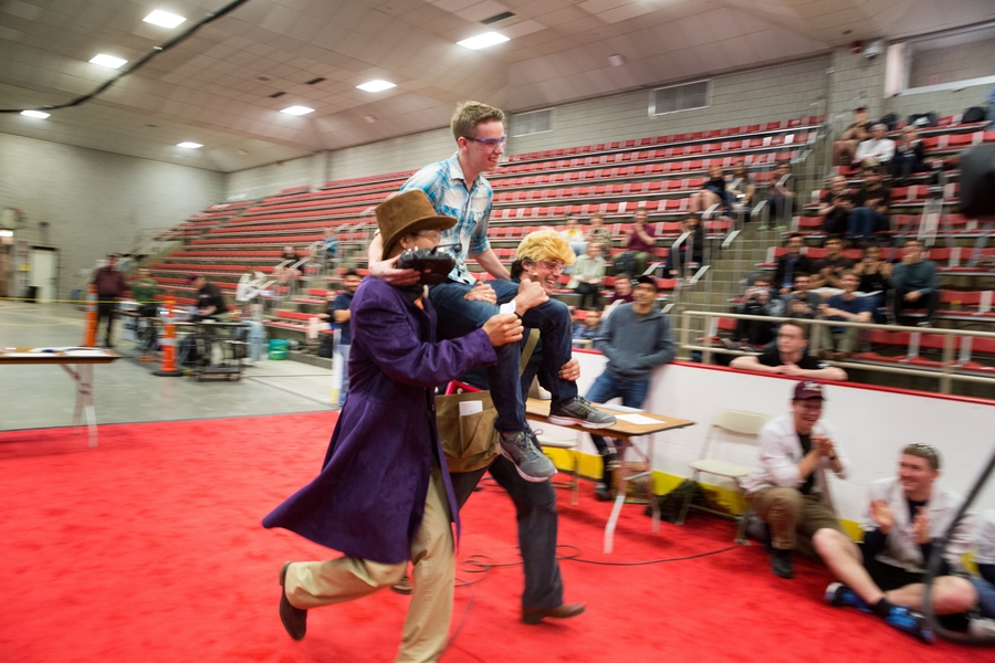 Winner Mason Massie is hoisted on the shoulders of course instructors Sangbae Kim (left) and Amos Winter (right) for a victory lap. 