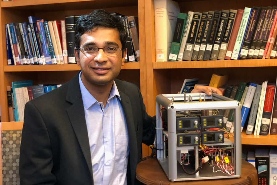 Ashok Ajoy PhD ’16, poses with a prototype hyperpolarizer device.
