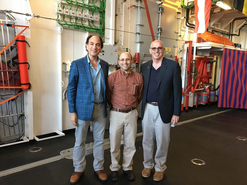 Chuck Goddard (right) on board the ITS Alpino stands with Nicholas Makris (left), professor of mechanical and ocean engineering and director of the Center for Ocean Engineering at MIT, and Joe Harbour, professor of the practice of naval construction and engineering at MIT.