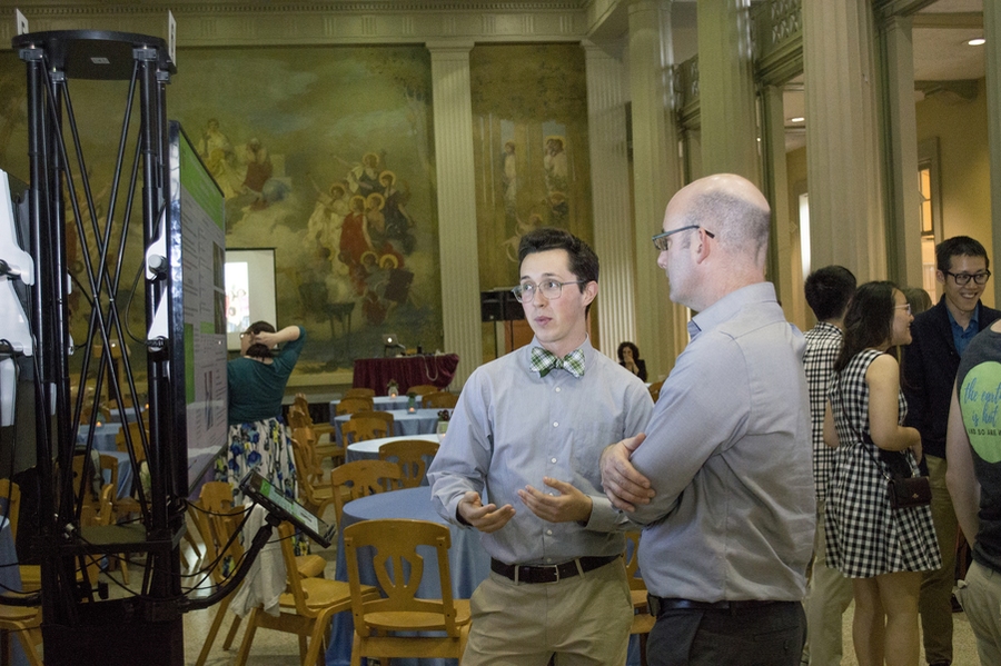 Senior Will Popov discusses the results of his capstone project with CEE Professor Jesse Kroll.