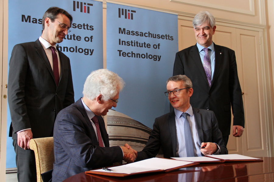 MIT Associate Provost Richard Lester shakes hands with Luc Sels, rector of KU Leuven, after signing the new agreement.