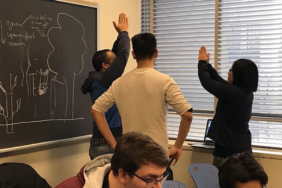 MIT undergraduate Mark Vrablic (standing, center) engages as the TA and mentor for a student group building a video game in the nine-day workshop that he helped design and publish on MIT’s OpenCourseWare along with Department of Materials Science and Engineering lecturer Kyle Keane and Andrew Ringler from the Interactive Materials Education Laboratory.