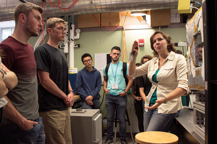 Graduate student Elise M. Strobach (right) explains research on aerogels for insulating windows and other uses during a tour of the Rohsenow Kendall Heat Transfer Laboratory, where she conducts research under Gail E. Kendall Professor Evelyn Wang. Listening (left to right) are Summer Scholars Michael Molinski, Simon Egner, Alvin Chang, and Fernando Nieves Munoz.