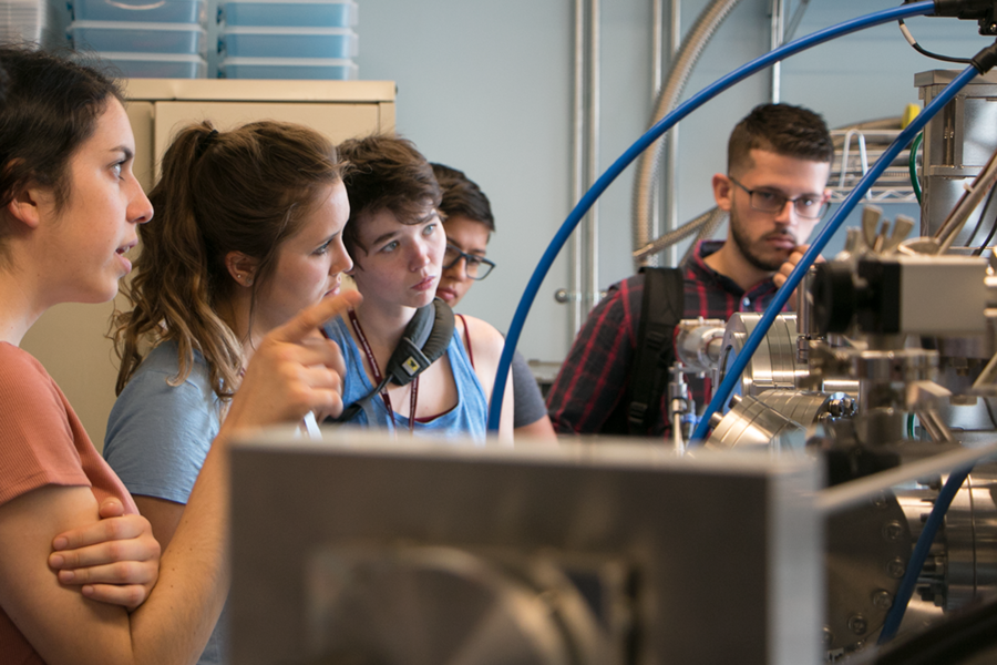 Summer Scholar Abigail Nason (left) asks a question about the molecular beam epitaxy machine used for making new extremely thin electronic materials during a tour of Rafael Jaramillo’s lab. Listening (from second left) are Sarai Patterson, Elizabeth (Lily) Hallett, Julianna La Lane, and Fernando Nieves Munoz.