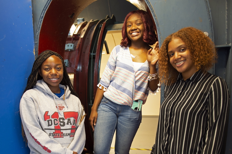 Snell, Sharrieff, and Skinner stand in the entrance to the Wright Brothers Wind Tunnel's test section. The students said the wind tunnel was a favorite part of their Aug. 3 MIT visit.