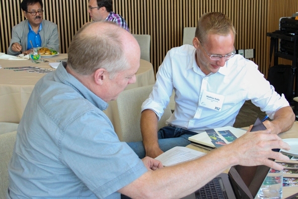 Timothy Swager (left) of the Department of Chemistry talks with Mathias Kolle, an assistant professor of mechanical engineering, at the J-WAFS research workshop in September.  Kolle and his team provided critical insight used to optimize the design of the food safety sensor being developed by Swager and Alexander Klibanov and their research teams.