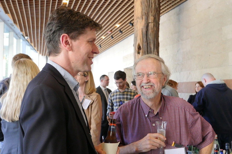 Professors Thomas Schwartz (left) and Graham Walker chatted at the symposium reception in Building 68.