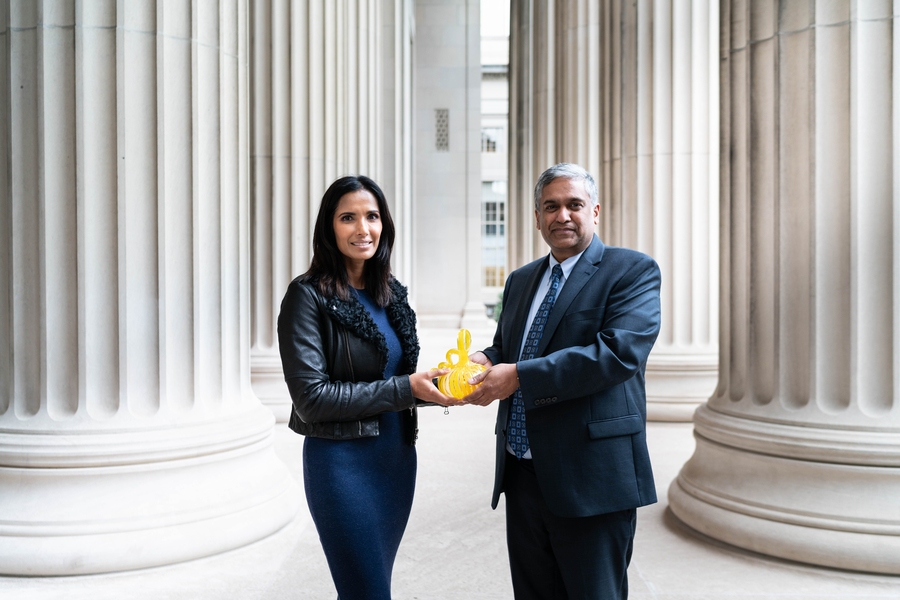 MIT visiting scholar Padma Lakshmi receives a welcome gift from Anantha Chandrakasan, dean of engineering and the Vannevar Bush Professor in the Department of Electrical Engineering and Computer Science. Yellow is the color of endometriosis awareness.