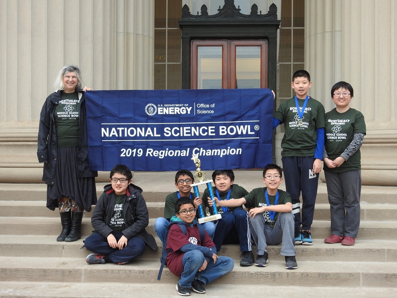 The winning students and their coach from Jonas Clarke Middle School's Team One pose with their medals and trophy.