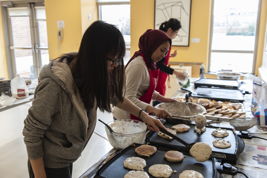 Brunch volunteers wake up early in the morning to begin preparing food for the event. 