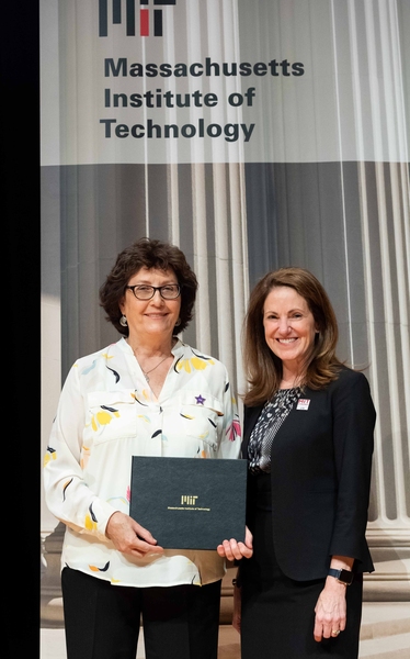 Elizabeth DeRienzo receives a Bringing out the Best award from Chancellor Cynthia Barnhart.