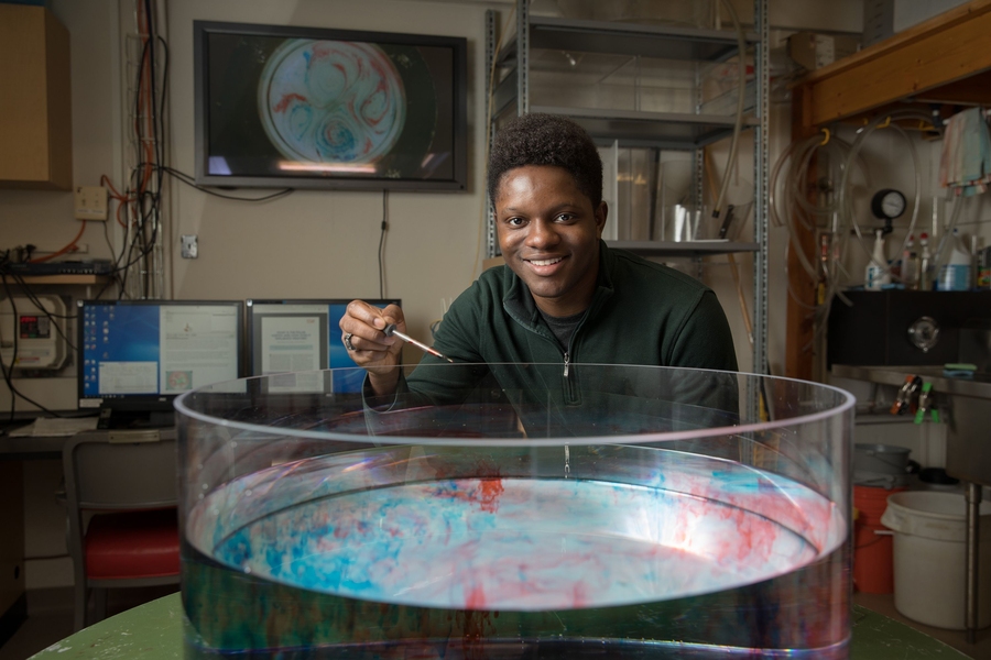 Jordan Benjamin uses a rotating water tank to demonstrate the bridge between observation and theory underlying weather and climate phenomena.