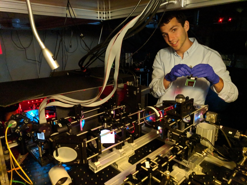 Dylan Cable prepares the Adaptive Upright Microscope, which will ultimately enable deeper imaging of animal brains.