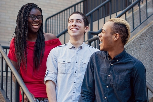 Founding planners of RAK Week, Bettina Arkhurst and Cory Johnson (left and right), share a moment with volunteer graphic designer Daniel Sanchez.