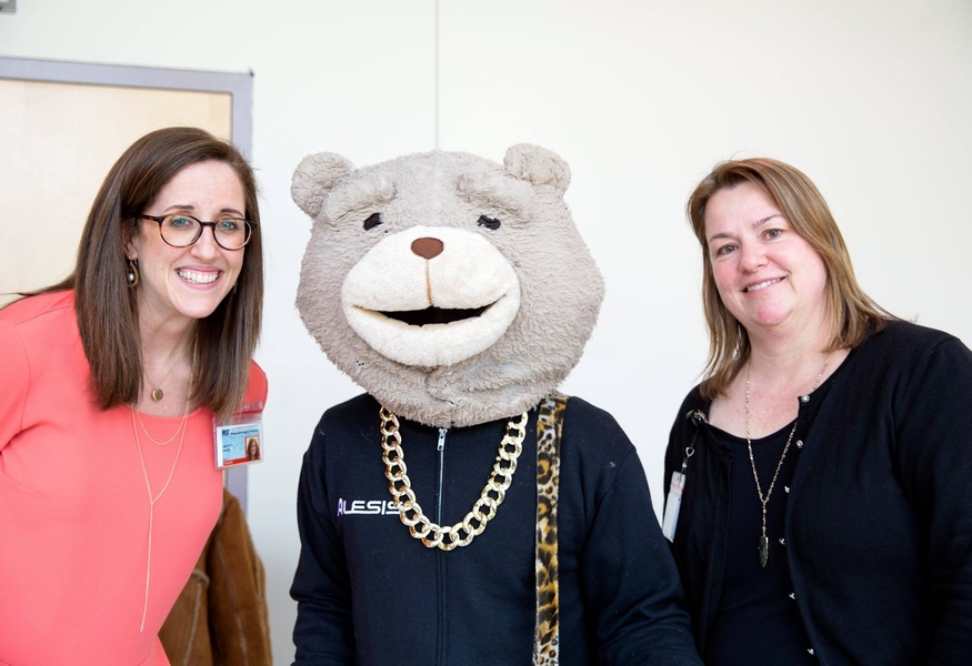 MIT Medical’s Executive Director Ashley Hague (left) and Medical Director Cecilia Stuopis share a moment with Keytar Bear.