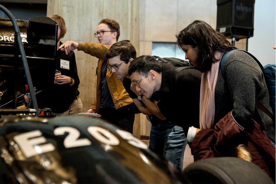 People clamored around the car to see and learn more about it.