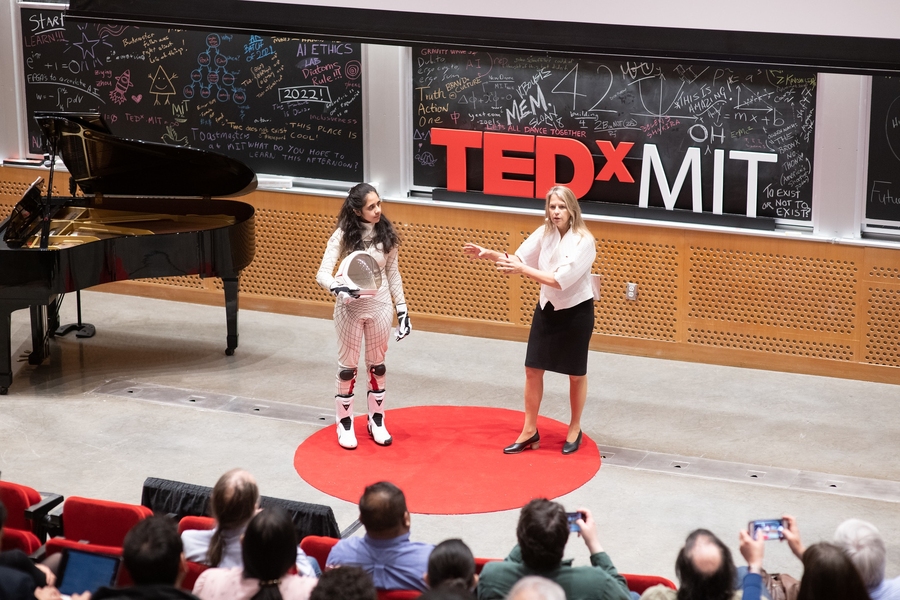 Professor of aeronautics and astronautics Dava Newman (right) spoke as TEDxMIT co-director Rucha Kelkar, a first-year MIT student, showed off a spacesuit prototype.