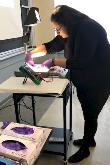 Testing multimeters: MIT electrical engineering and computer science graduate student Taqiyya Safi tests multimeters during the Science, Engineering, and Technology (SET) in the City program, sponsored by the Boston Area Girls STEM Collaborative.