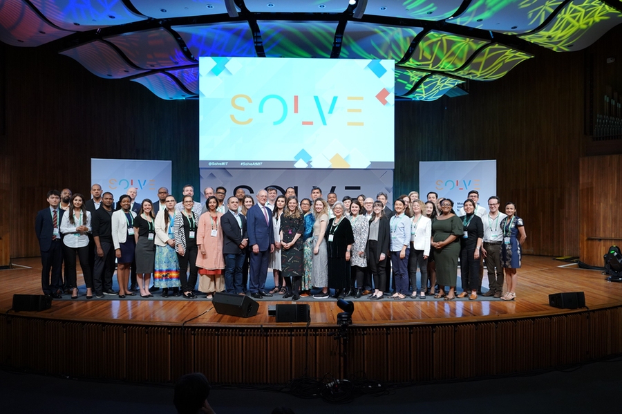 MIT President L. Rafael Reif and Solve Executive Director Alex Amouyel recognize Solver teams on stage.