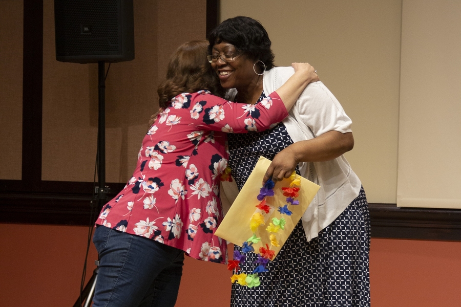 Infinite Mile Awards committee member Lisa Horowitz embraces award recipient Barbara Williams