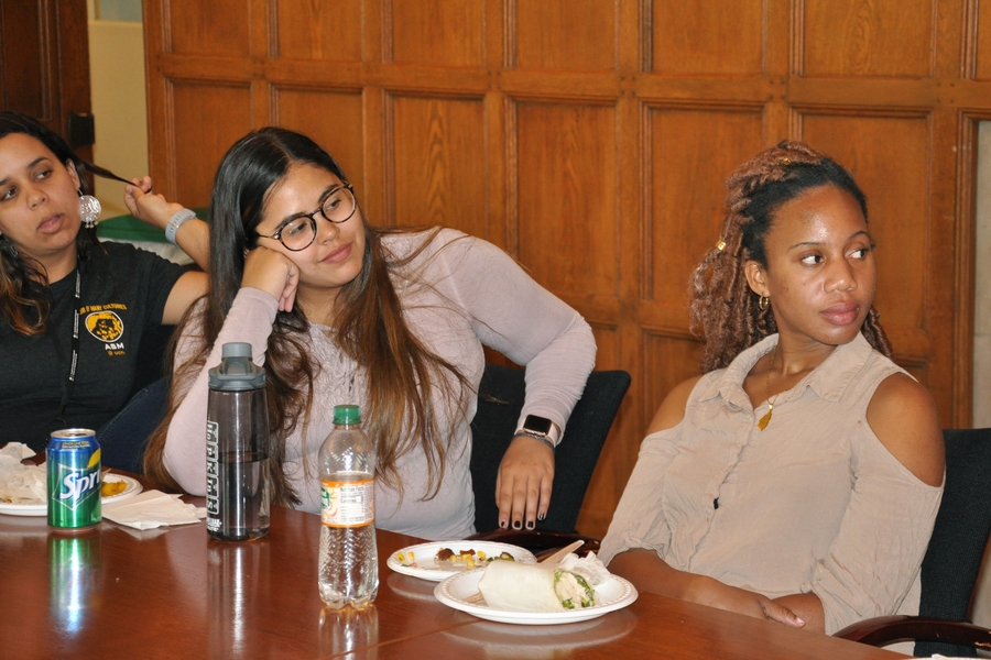 Three current MSRP students enjoy Squire Booker's inspiring story about his path to academia.