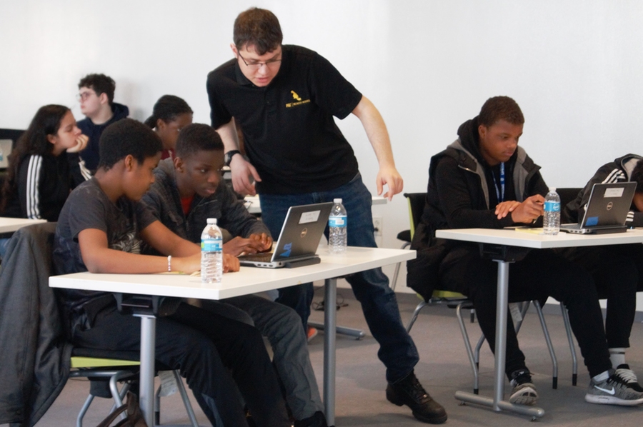 Andrew Fishberg checks on a student's progress.