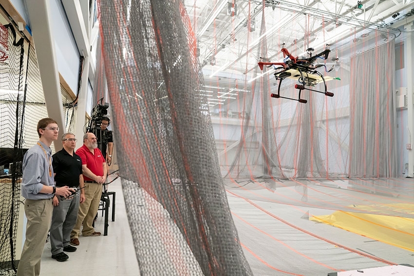 A student in the UAS-SAR course flies a drone equipped with a radar to map a hidden area inside the MIT AeroAstro building.