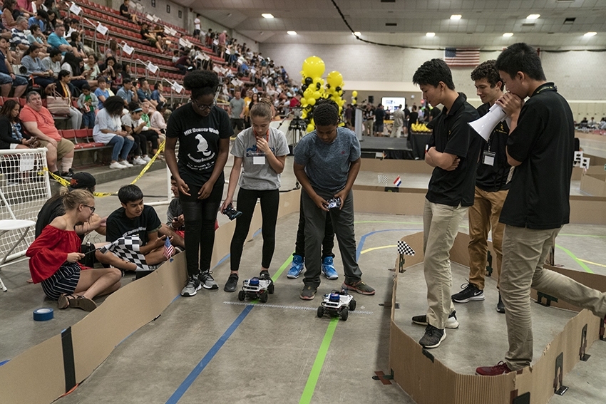 Middle school students race their programmed RACECARs at the BWSI final event.