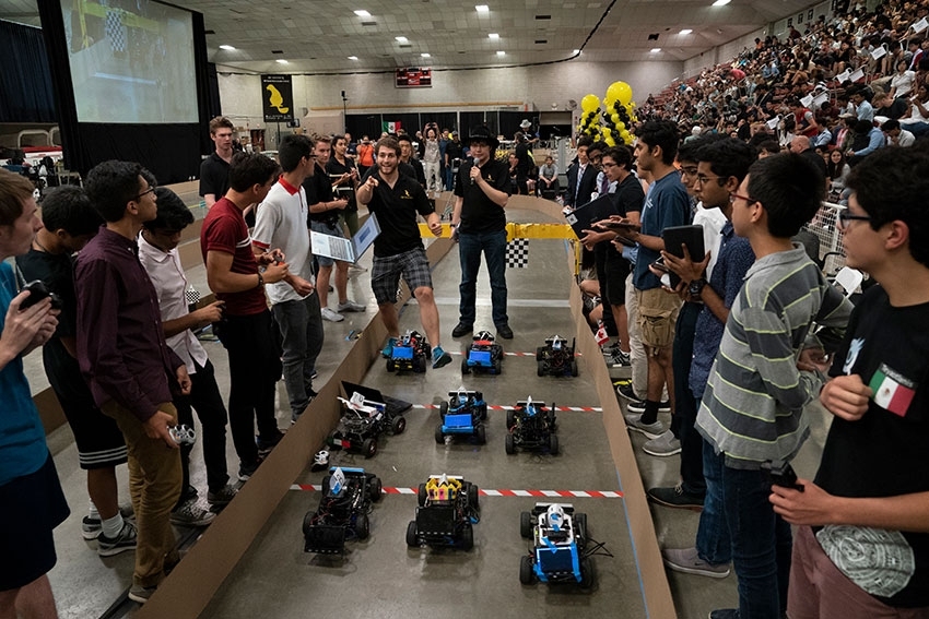 At the Beaver Works Summer Institute final event, teams of students prepare to race autonomous racecars around an obstacle course in the MIT Johnson Ice Rink.