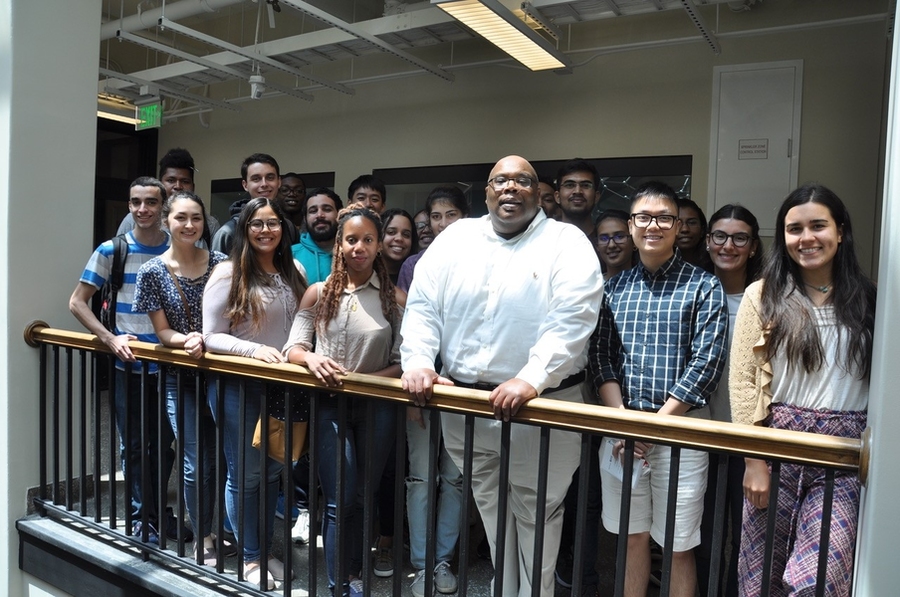 Squire Booker ’94 (third from right in the front) stands with MSRP-Bio students at a luncheon in May.