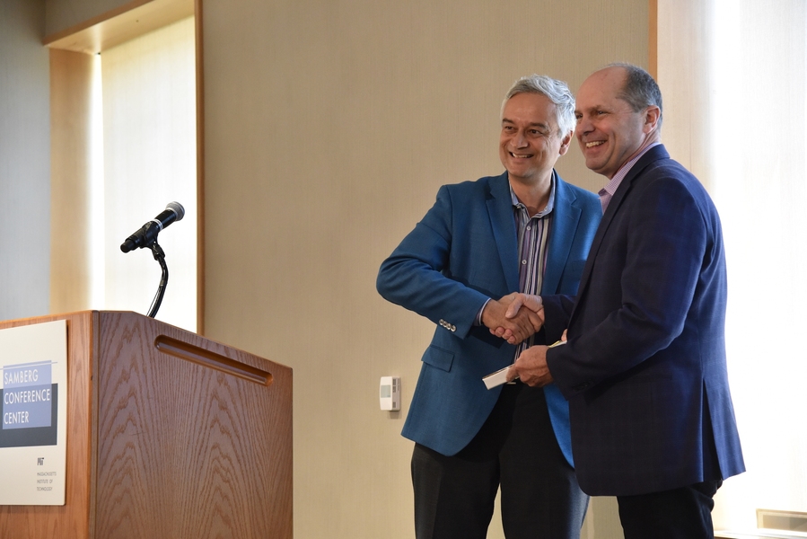 Chris Caplice (right) receives the MITx Prize for Teaching and Learning with MOOCs from Krishna Rajagopal in 2018.