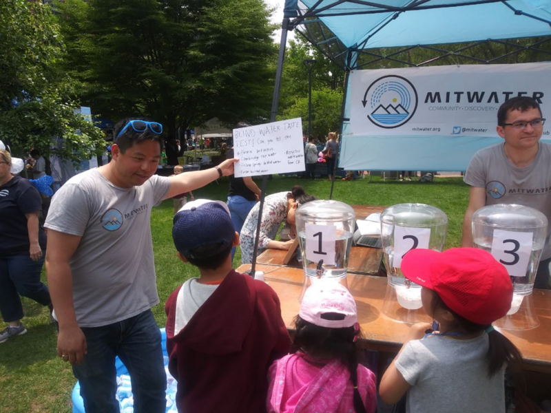 MIT students from the Water Club explain their water taste test to attendees of the Cambridge River Arts Festival. 