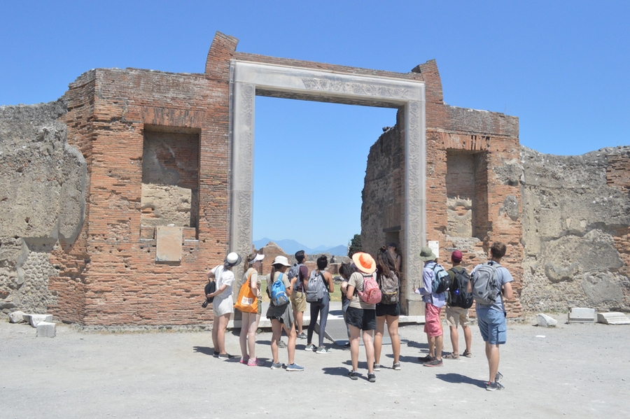 Students examined the ancient structures at the once-buried city of Pompeii. 
