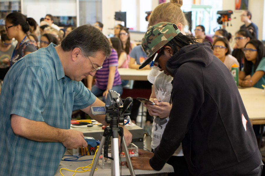 MIT Professor Steven Leeb (left) conducts a test of a DC motor for team members participating in the Dustbusting by Design spin-off competition in the Pappalardo Lab at MIT. 