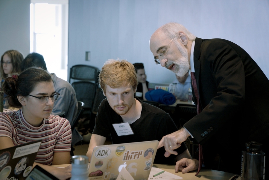 Professor John Sterman discusses possible policy options with students participating in the “SimPlanet” event.