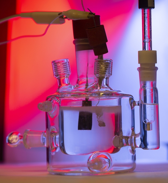 A three-electrode cell setup to measure the activity of catalysts for electrochemical water splitting. Oxygen is produced at the planar ruthenium dioxide electrode and hydrogen is produced at the platinum wire.