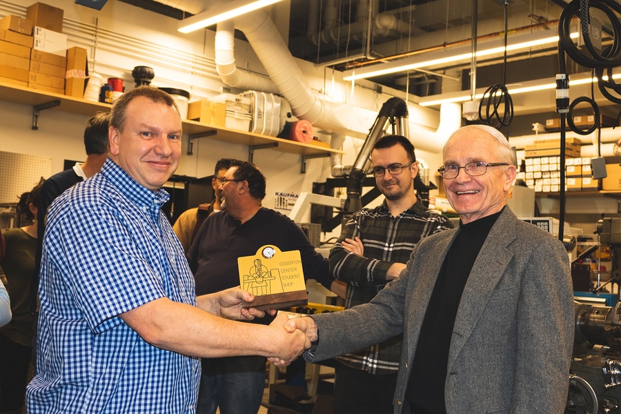 Mark Belanger, manager of the Edgerton Student Shop, accepts the plaque acknowledging his 15 years of service to students from Professor J. Kim Vandiver, Forbes Director of the Edgerton Center.