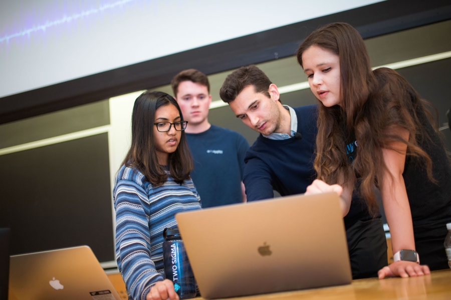 Alexander Amini (second from right) speaks with teaching assistants (left to right) Roshni Sahoo, Jacob Phillips, and Julia Moseyko.