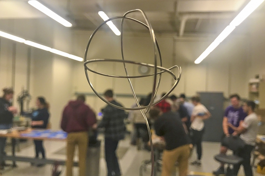 A hand-wrought cage (foreground) was eventually surrounded by glowing plasma once IAP students completed the step-by-step process of building a fusor in MIT Nucleus, a new nuclear makerspace at MIT.
