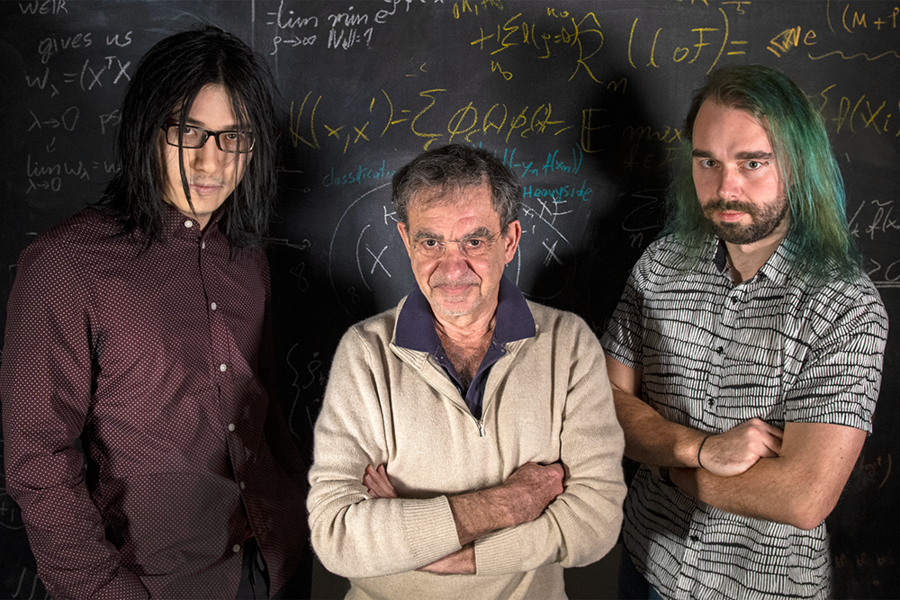MIT researchers (left to right) Qianli Liao, Tomaso Poggio, and Andrzej Banburski stand with their equations. 
