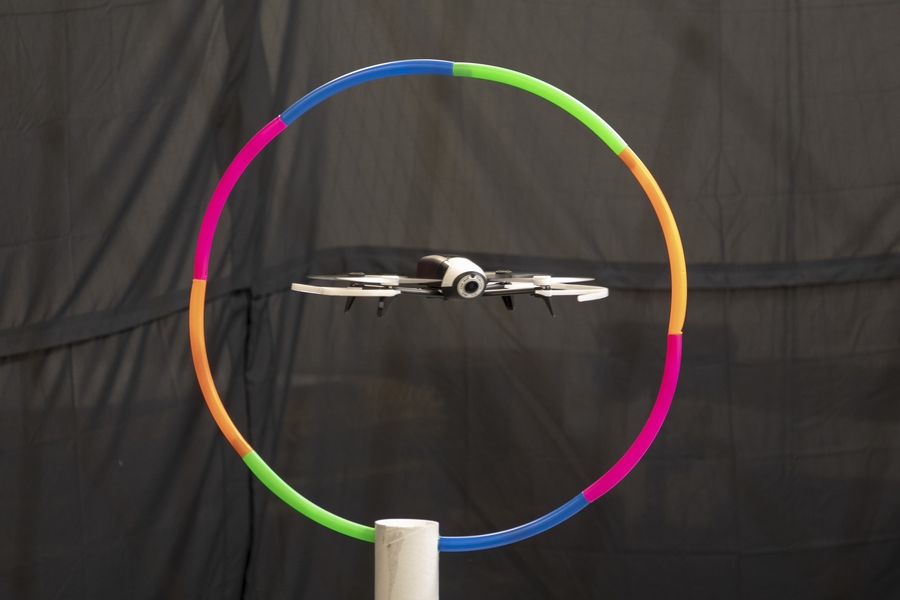 The Conduct-A-Bot system enables users to fly a drone through an obstacle course environment.