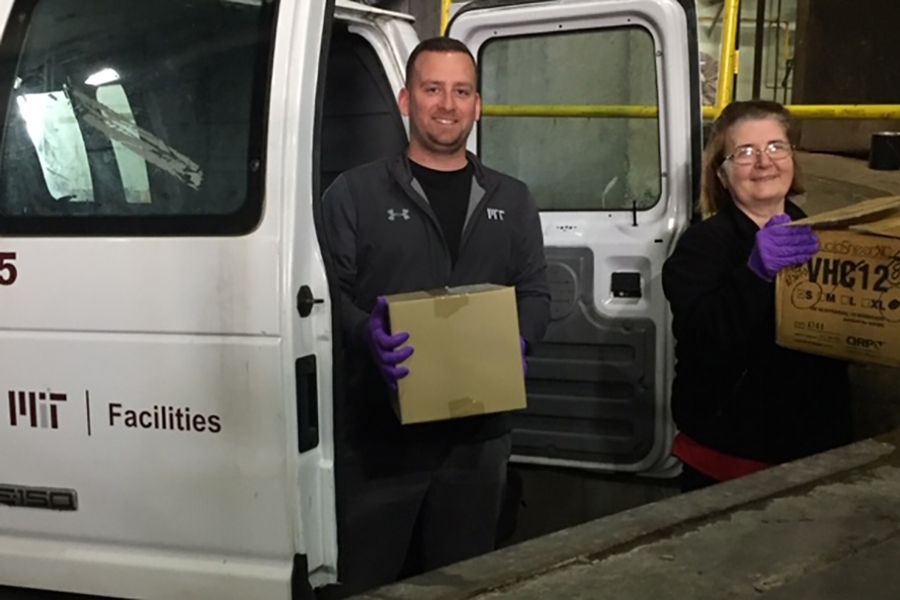 Mail Services Supervisor Darren O’Conner (left) and mail processor Sue Monteiro prepare a shipment of PPE to Mt. Auburn Hospital.