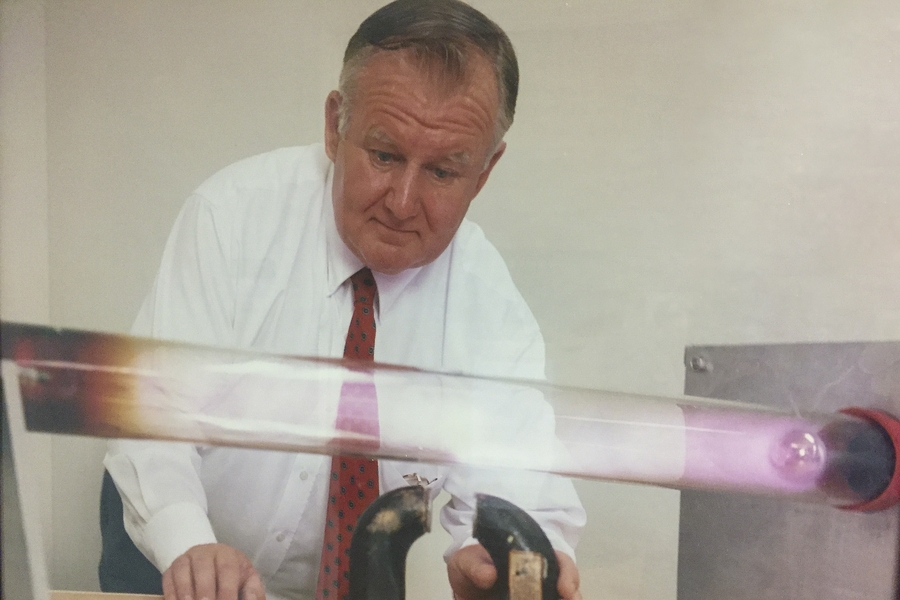 Paul Thomas moves a magnet beneath a glowing plasma in a discharge tube, one of the many demonstrations he built as part of his Mr. Magnet Science Show.