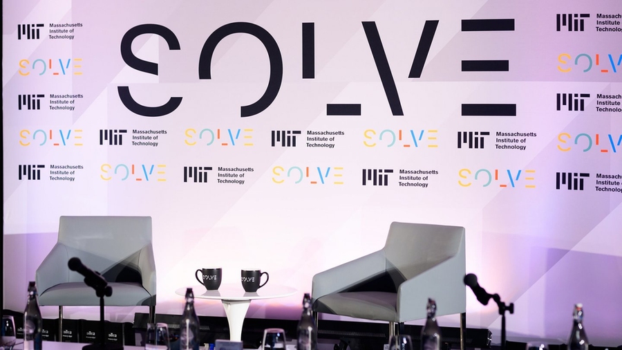 Photo of empty chairs before the Solve logo