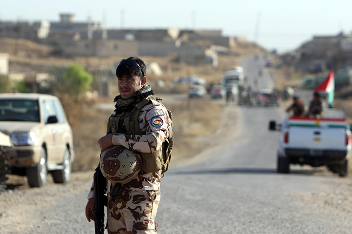 Photo of a soldier in front of convoy