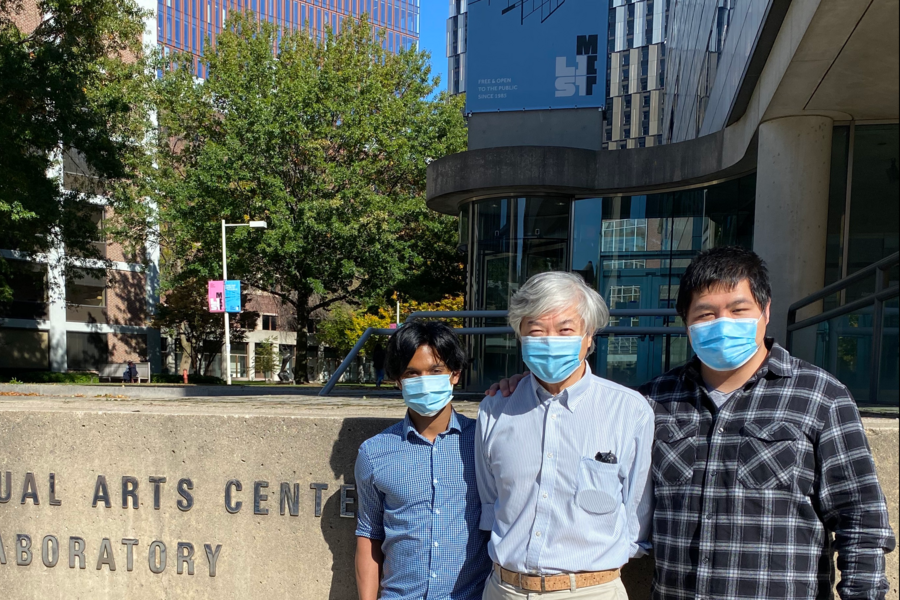 A photo of three MIT researchers wearing protective masks.