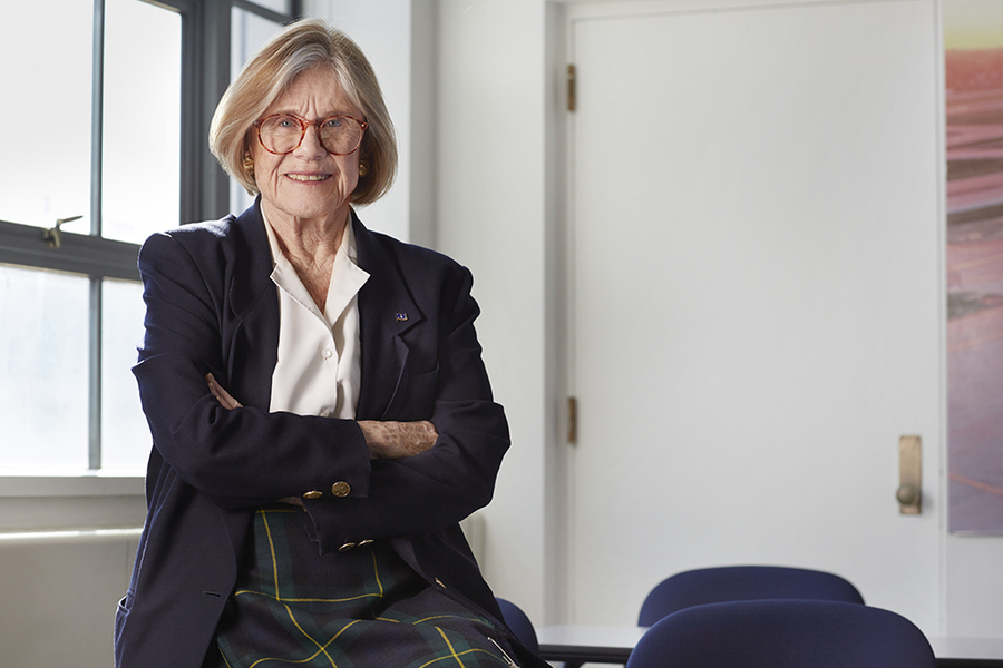 Portrait of Institute Professor Emerita Sheila Widnalls sitting near a window with arms folded