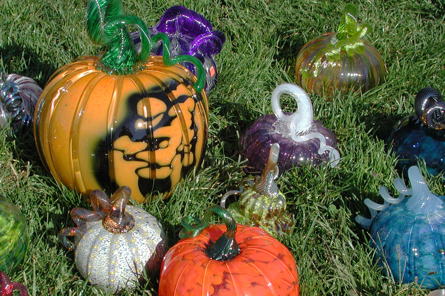 Photo of glass pumpkins displayed on the grass