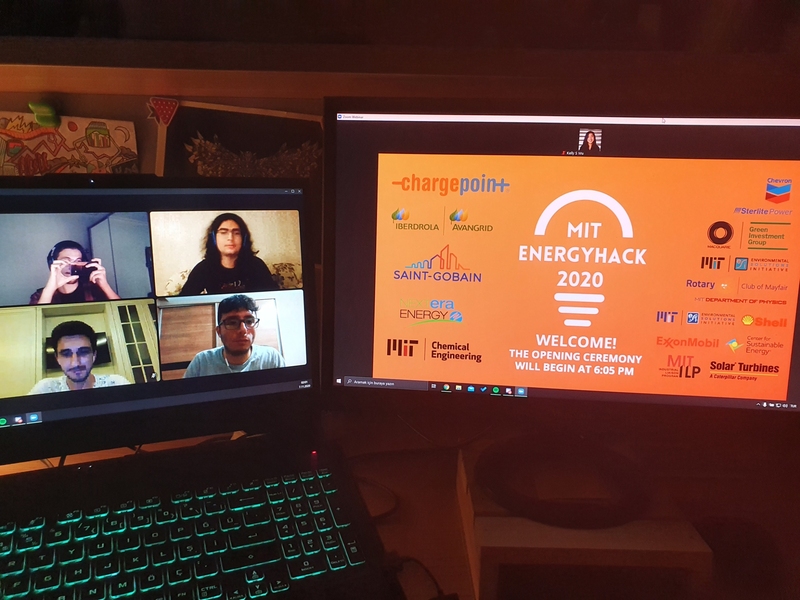 A photo of four people in a Zoom room on a laptop (left) and an orange MIT EnergyHack logo on monitor (right)